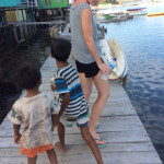 Kids strolling along the boardwalk with a couple of chickens